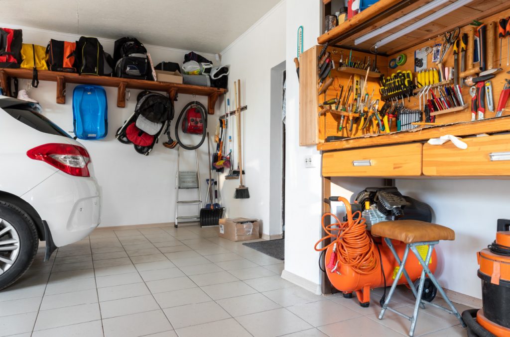 A photo of a clean garage with a car and many tools
