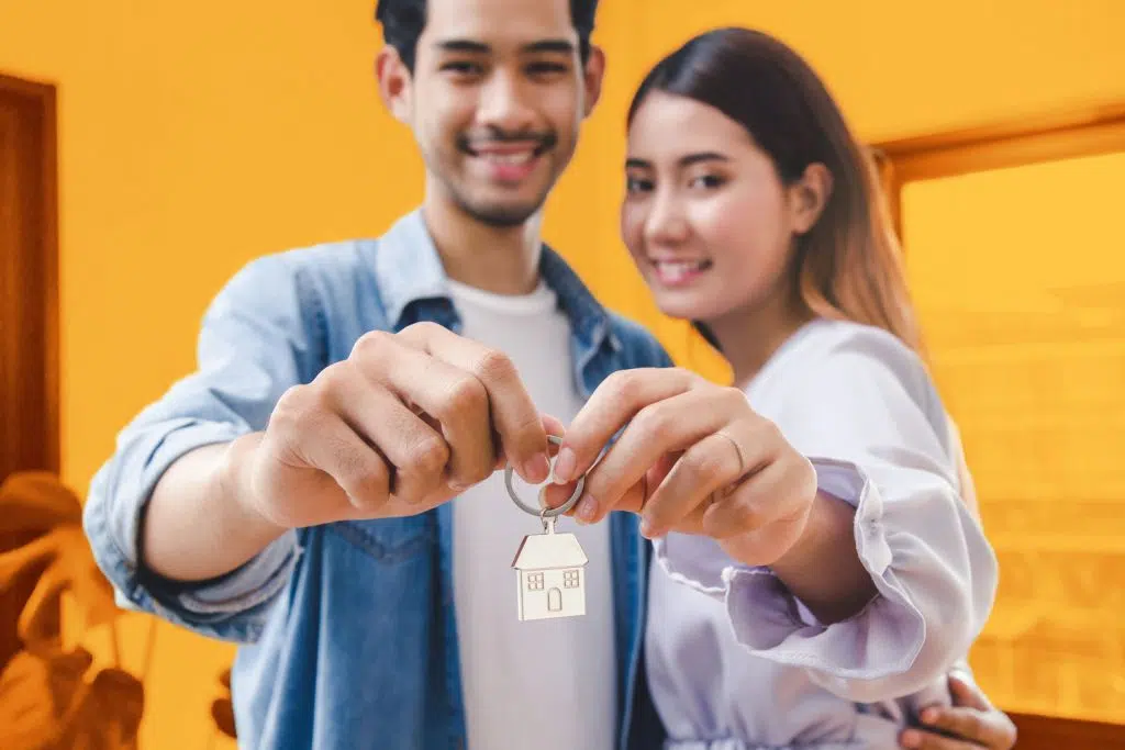 A couple with their own home keys through a Renters Advantage loan