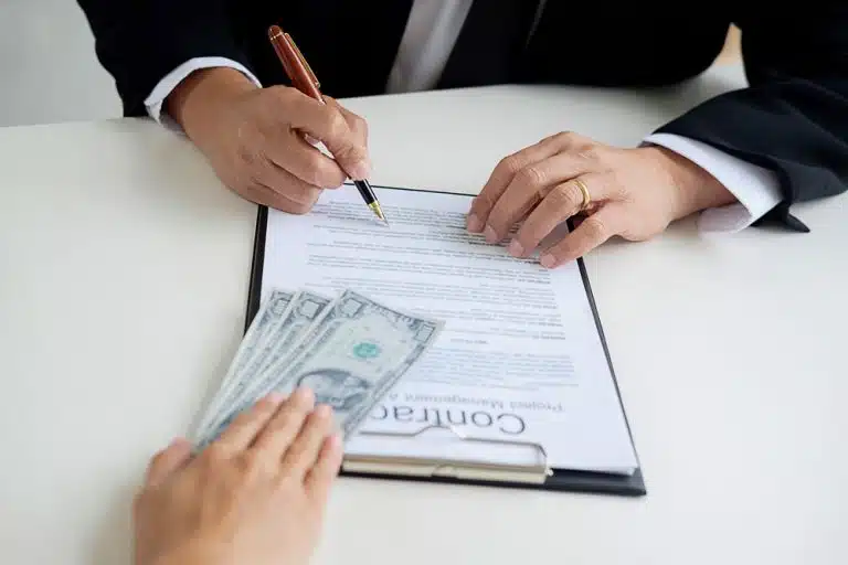 Signing a loan at Synergy One Lending