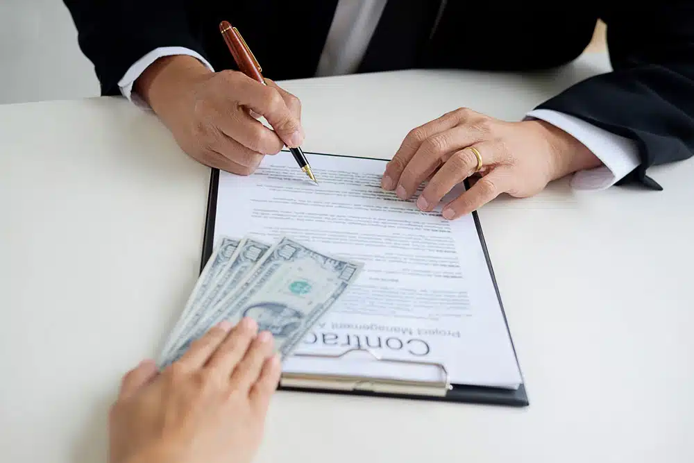 Signing a loan at Synergy One Lending