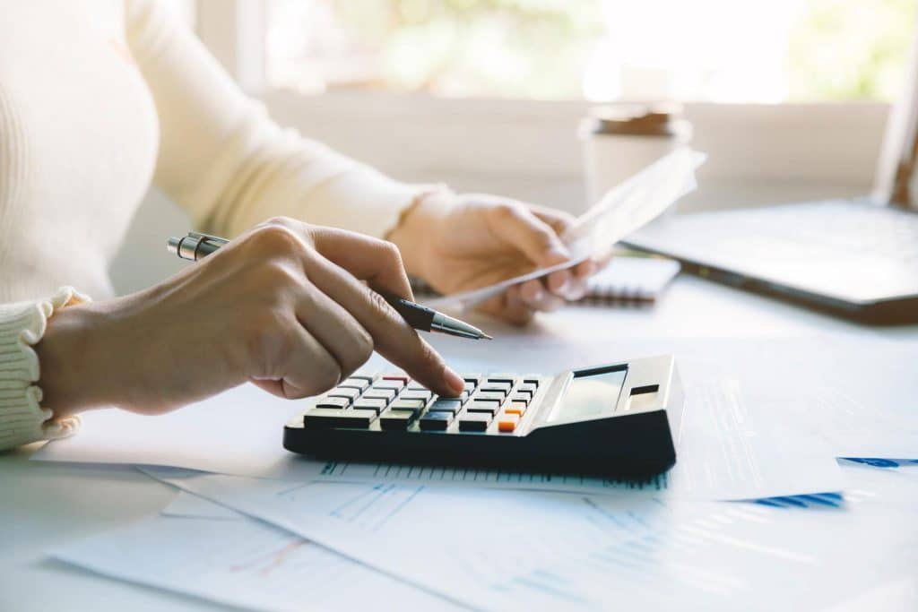 Woman at desk calculating taxes