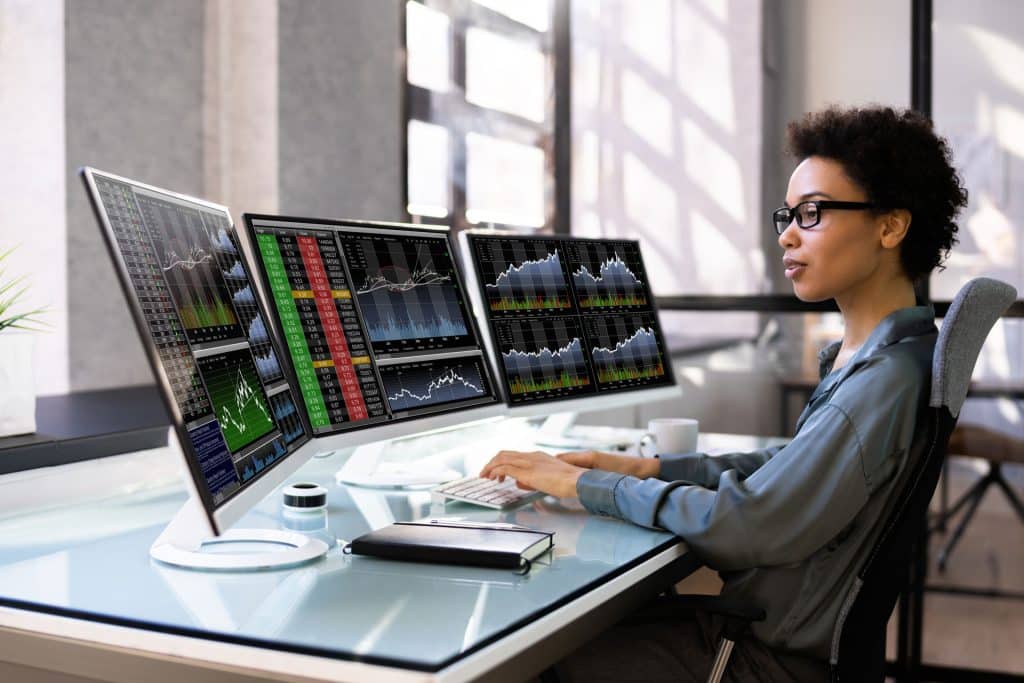 Young girl reading the stocks on a computer